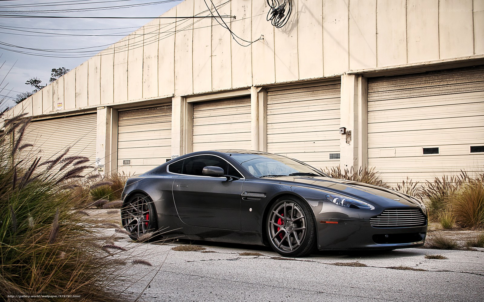 Black Aston Martin in industrial lot