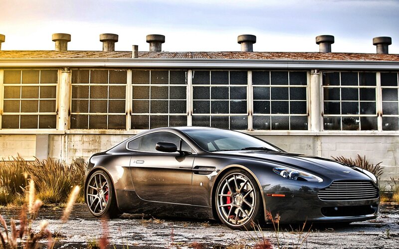 Black Aston Martin in industrial setting