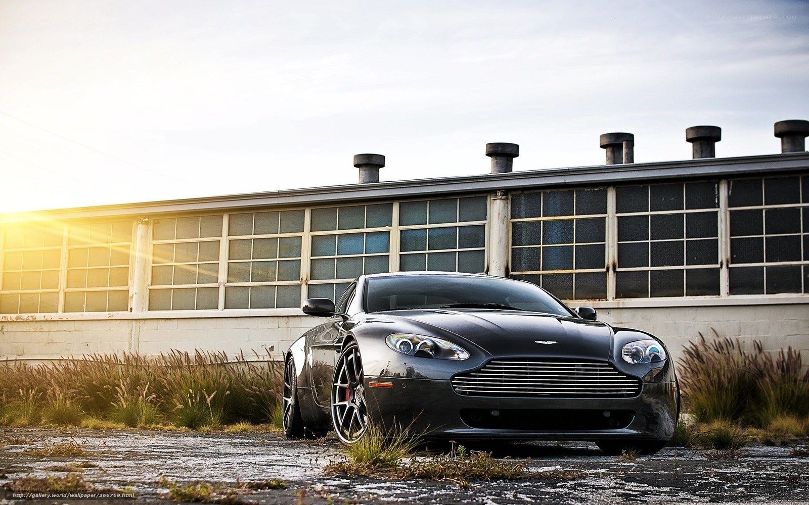 Black Aston Martin in industrial setting