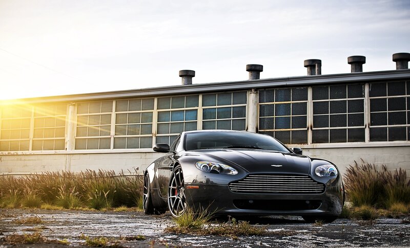 Black Aston Martin in industrial setting