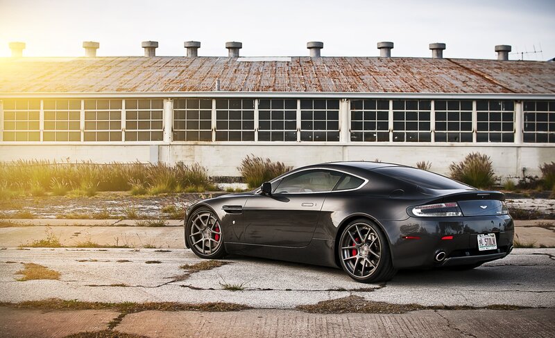 Black Aston Martin in industrial setting