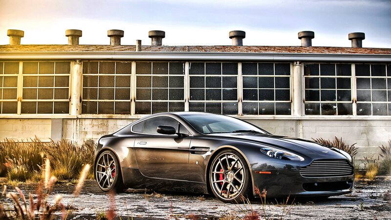 Black Aston Martin in industrial setting