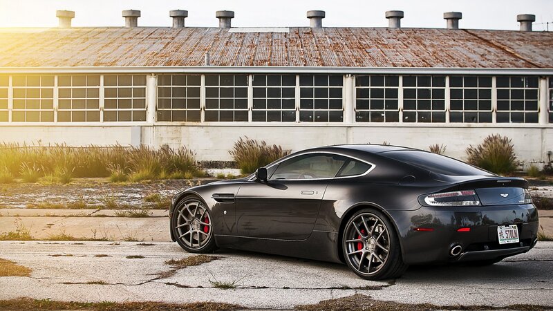 Black Aston Martin in industrial setting