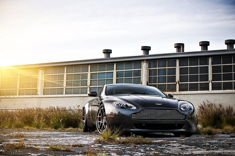 Black Aston Martin in industrial setting