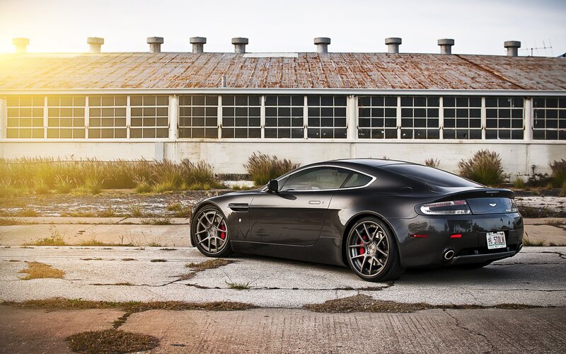 Black Aston Martin in industrial setting