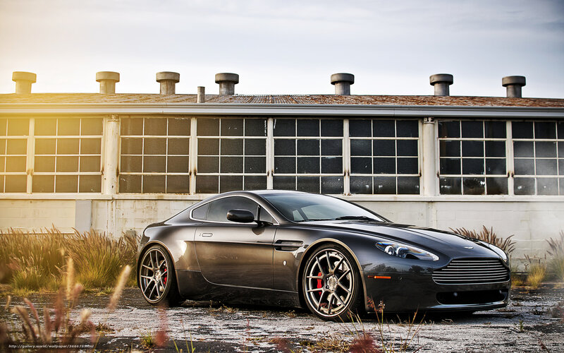 Black Aston Martin in industrial setting