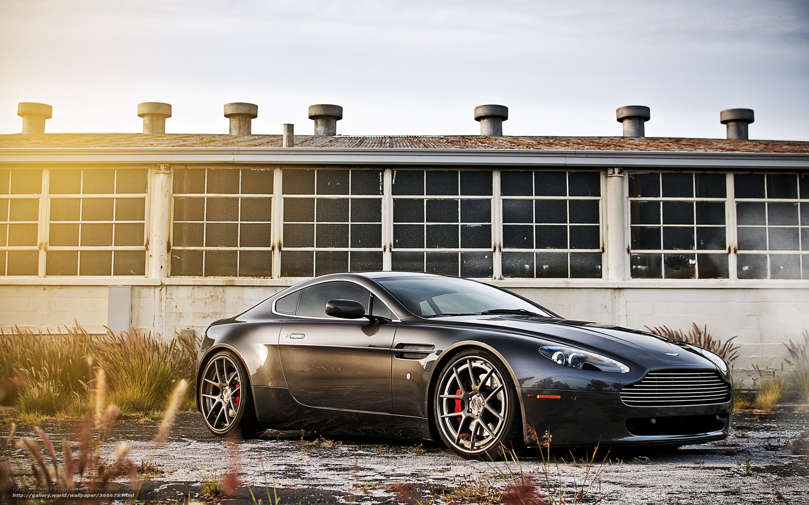 Black Aston Martin in industrial setting