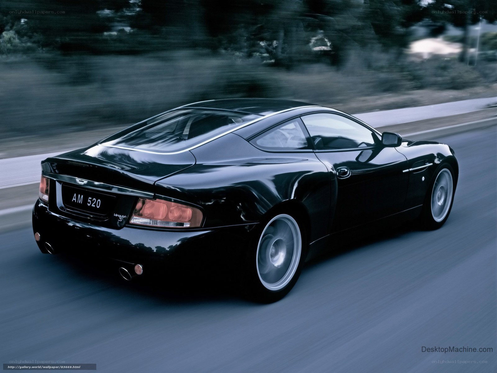 black aston martin in motion