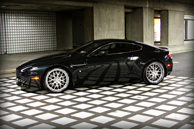 Black Aston Martin in parking garage