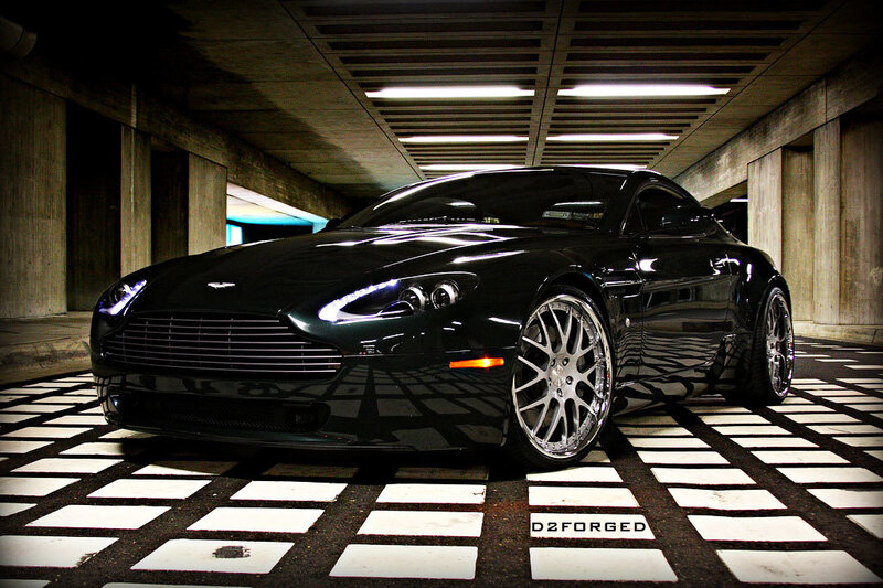 Black Aston Martin in parking garage