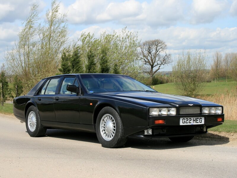 Black Aston Martin on a country road