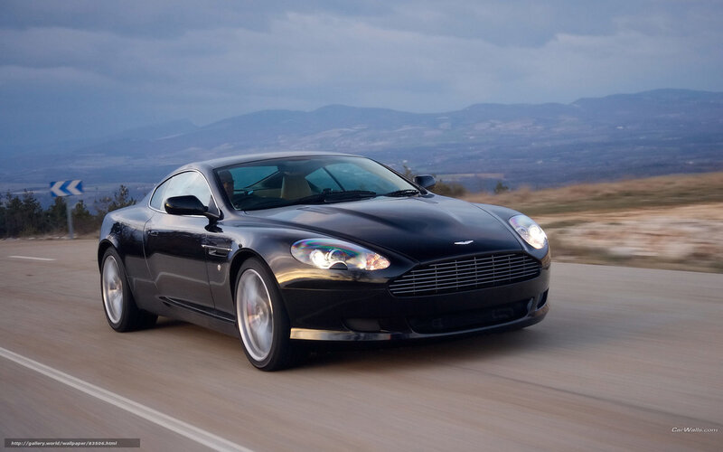 Black Aston Martin on a mountain road