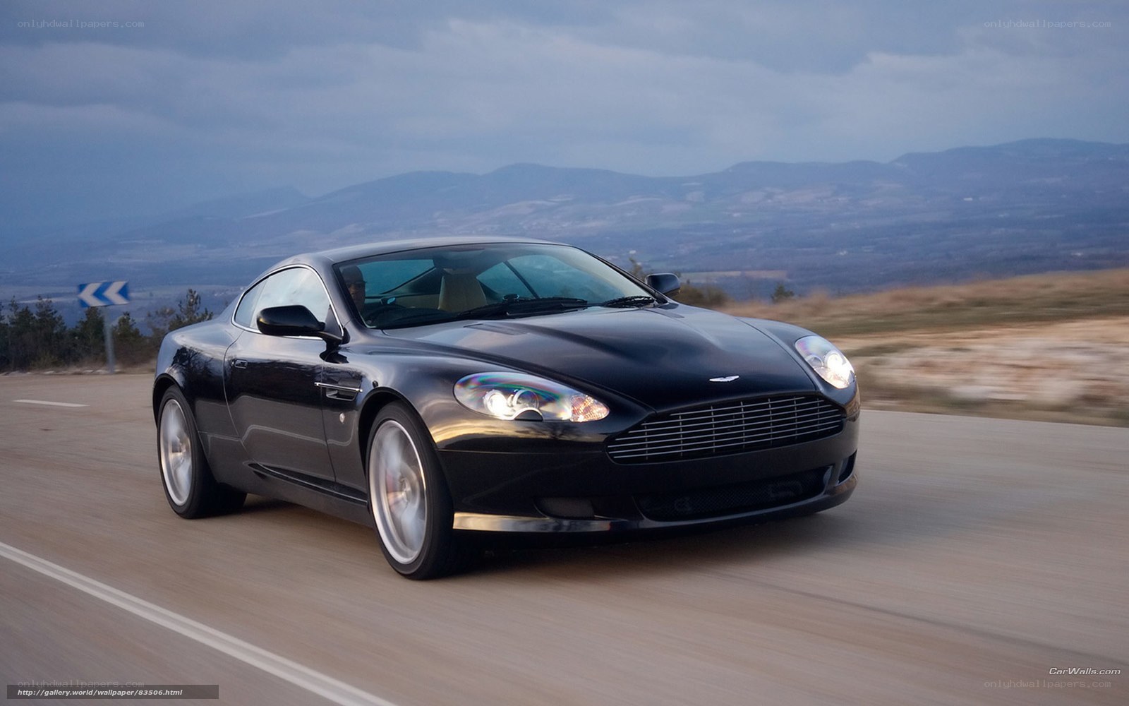 Black Aston Martin on a mountain road
