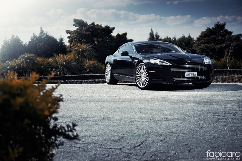 Black Aston Martin on a road