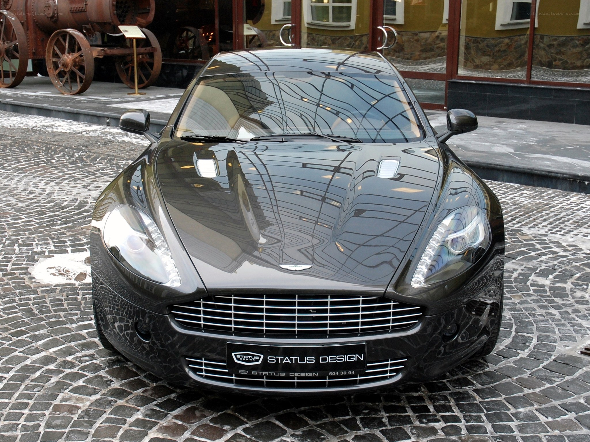 Black Aston Martin on cobblestones