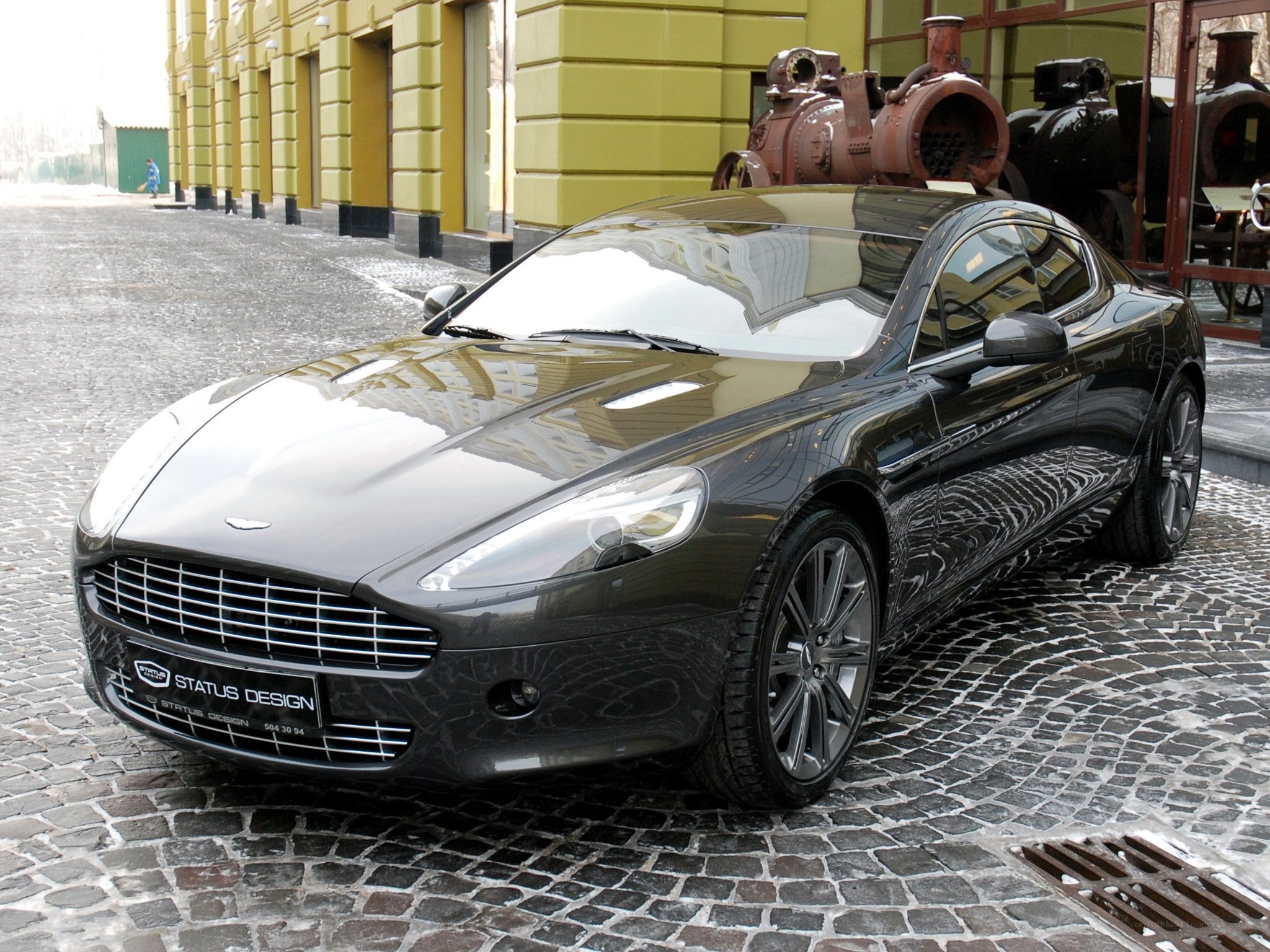 Black Aston Martin on cobblestones