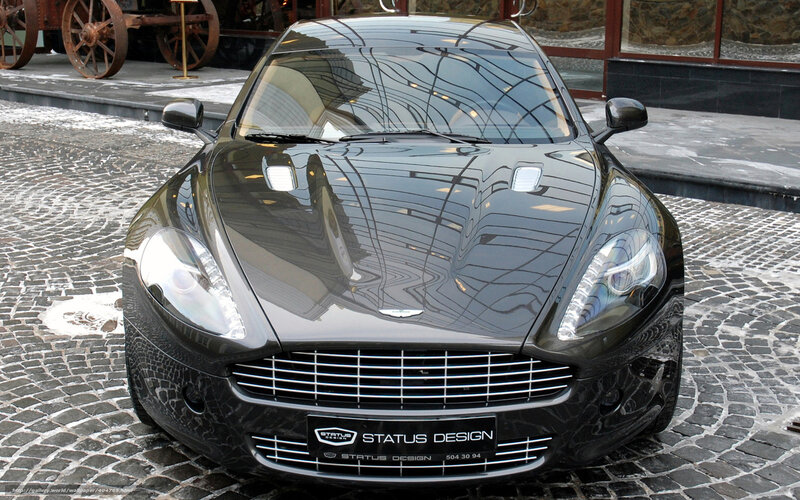 Black Aston Martin on cobblestones