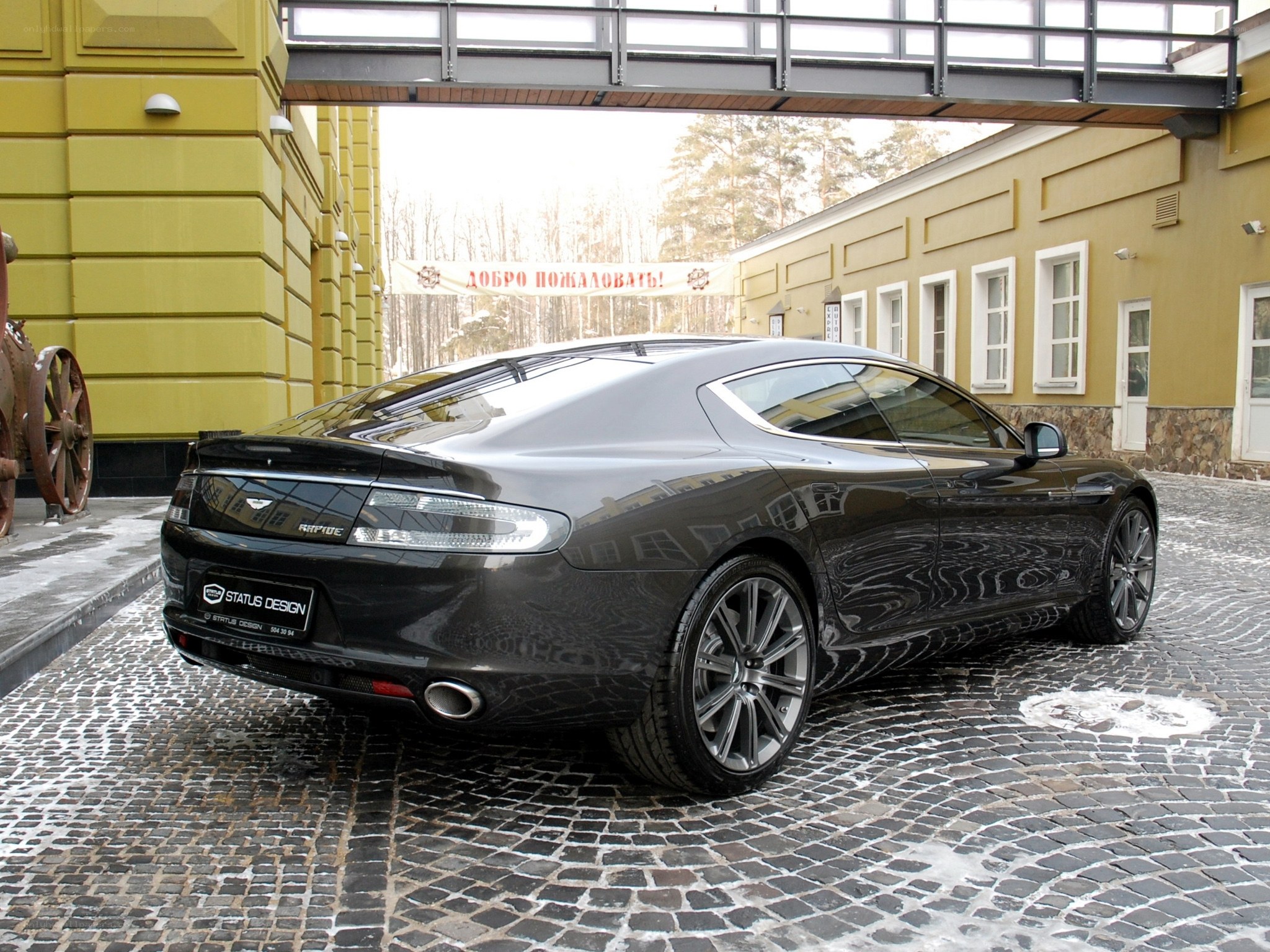 Black Aston Martin on cobblestones