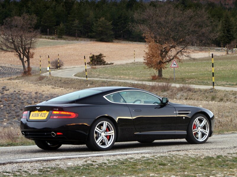 Black Aston Martin on country road