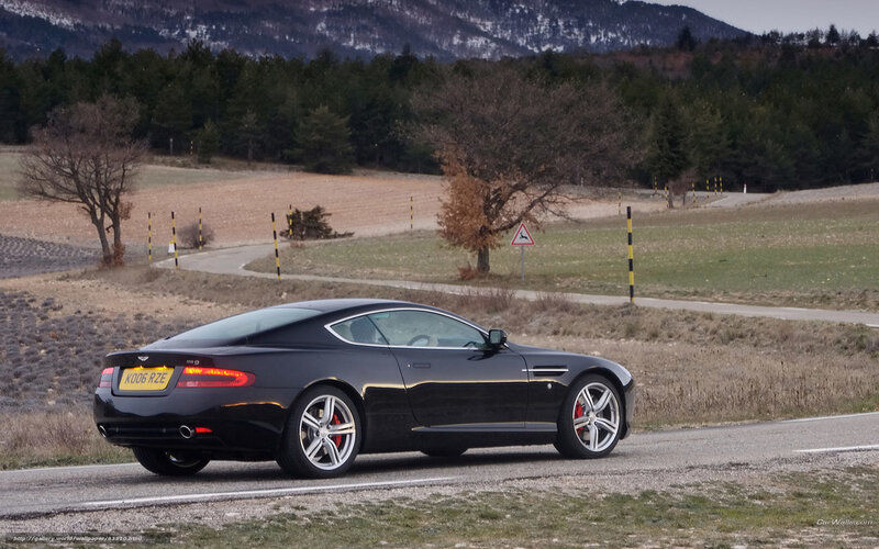 Black Aston Martin on country road