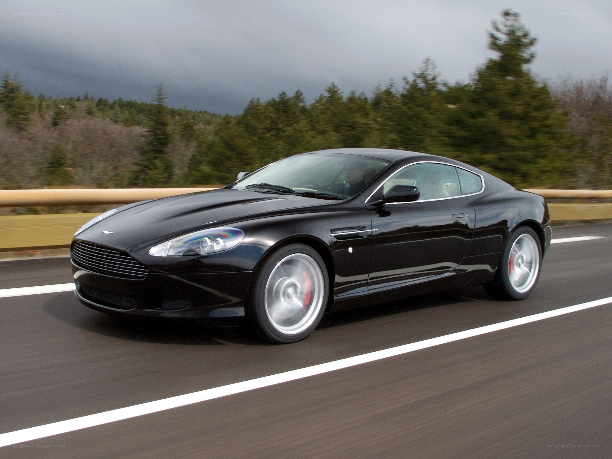 Black Aston Martin on highway