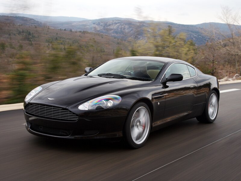 Black Aston Martin on mountain road