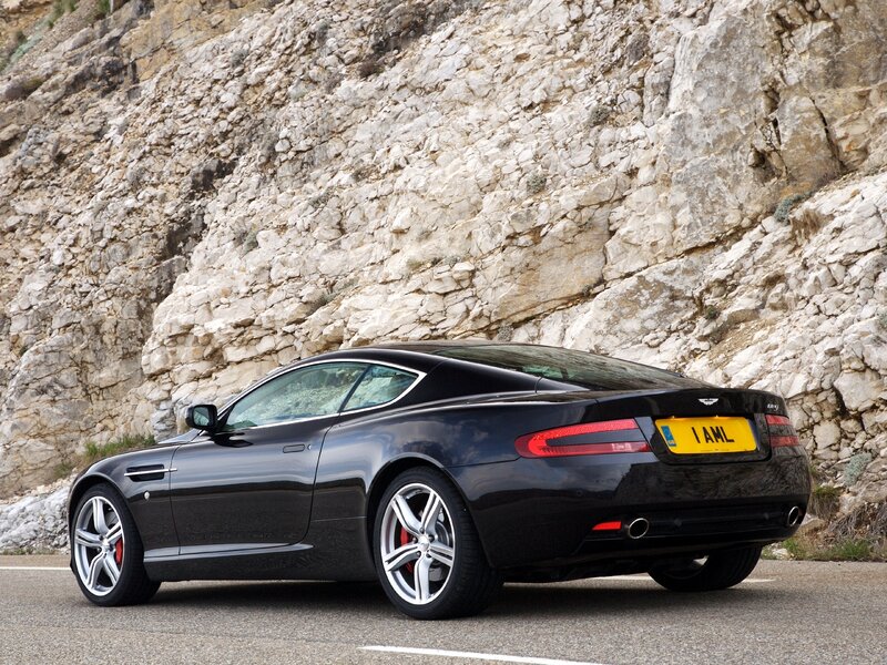 Black Aston Martin on mountain road