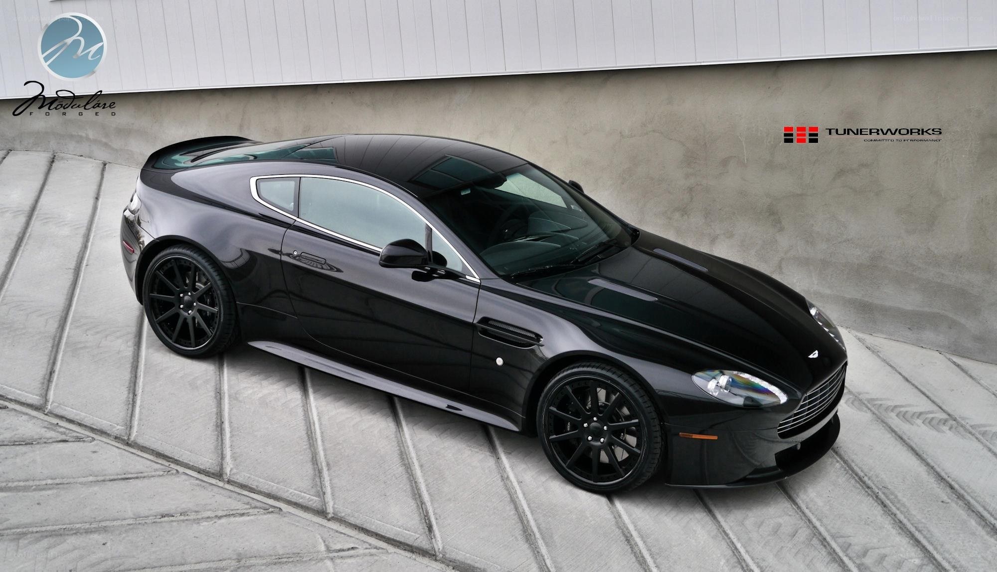 Black Aston Martin with custom wheels