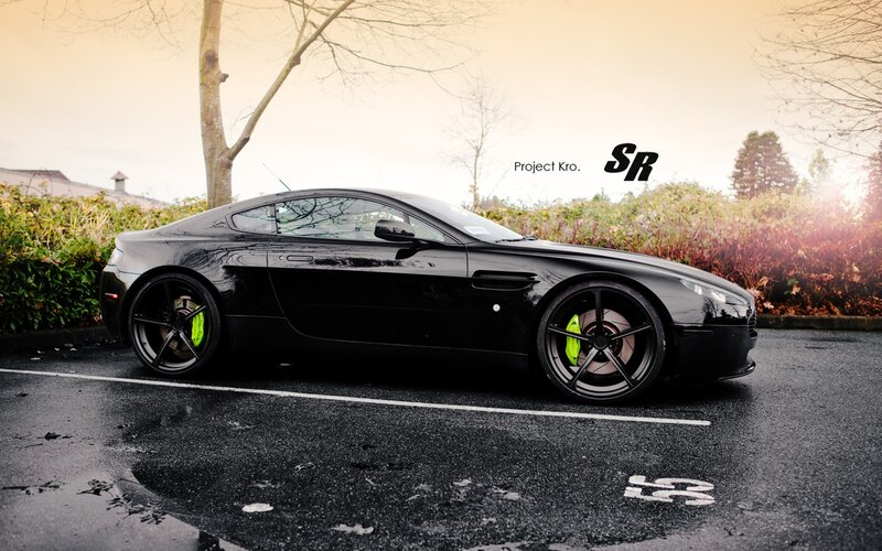 Black Aston Martin with green brakes