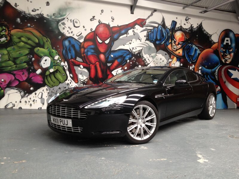 Black Aston Martin with superhero mural