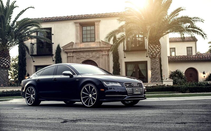 Black Audi A7 in front of a mansion