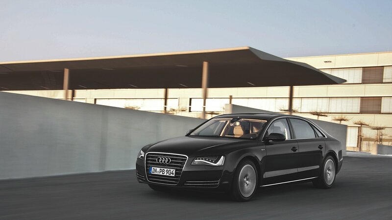 Black Audi A8 driving on a road