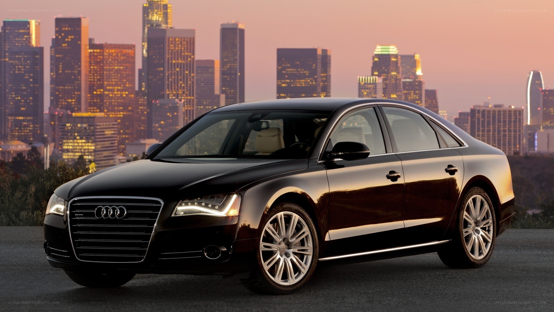 Black Audi A8 in cityscape