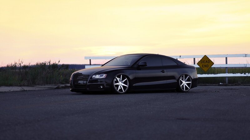 black audi coupe at sunset