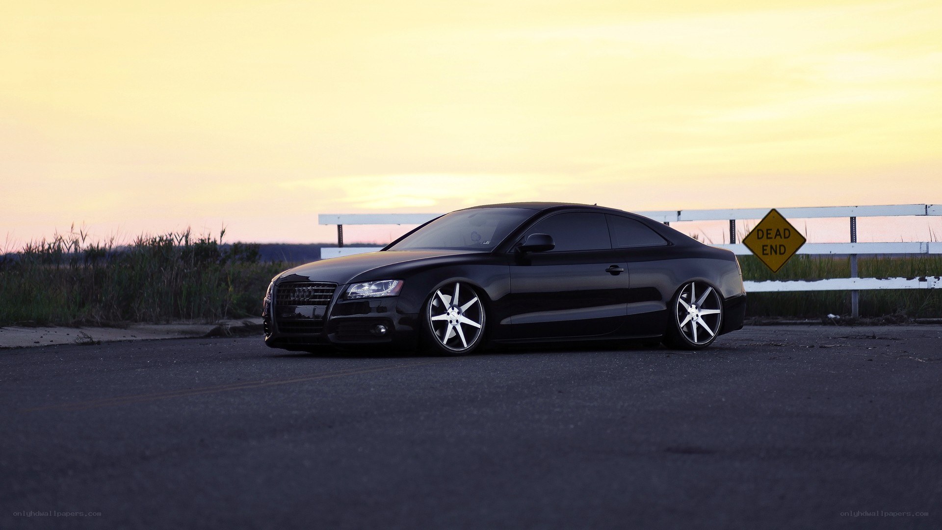 black audi coupe at sunset