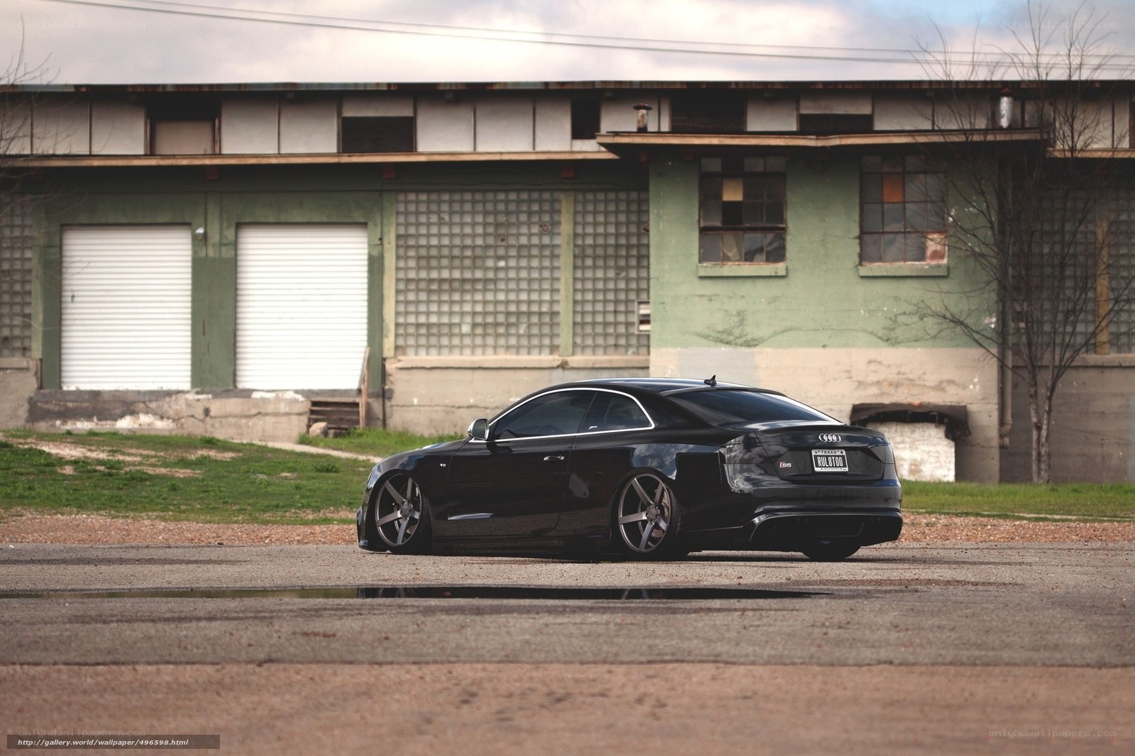 Black Audi coupe in industrial setting