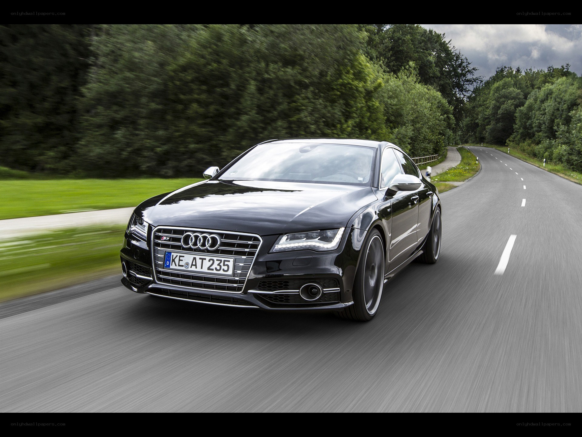 Black Audi driving on a road