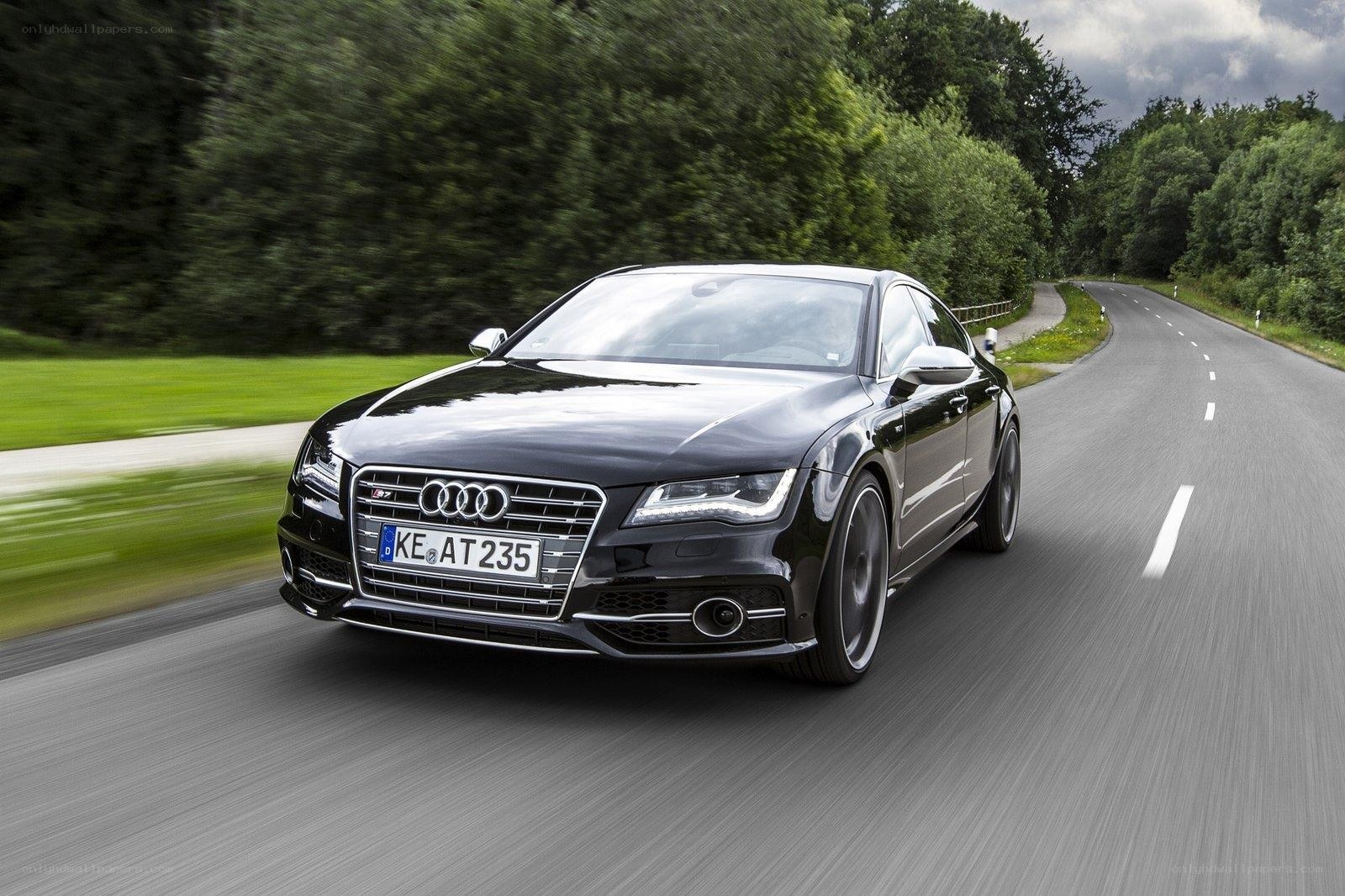 Black Audi driving on a road