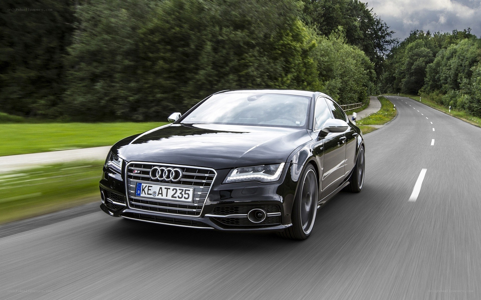 Black Audi driving on a road