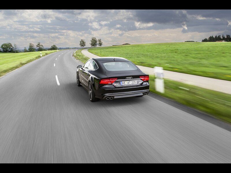 Black Audi driving on country road