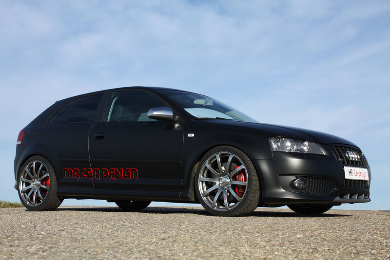 Black Audi hatchback with custom wheels