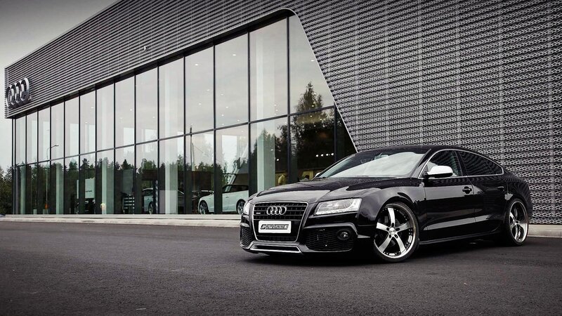 Black Audi in front of dealership