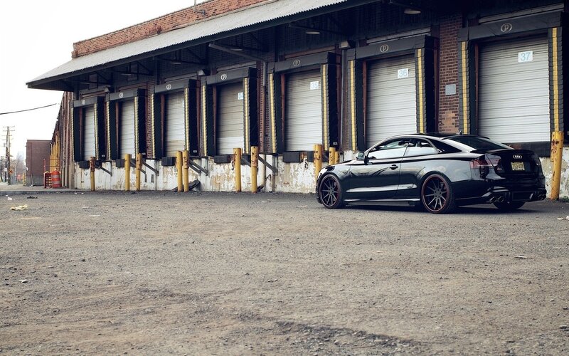 Black Audi in front of warehouse