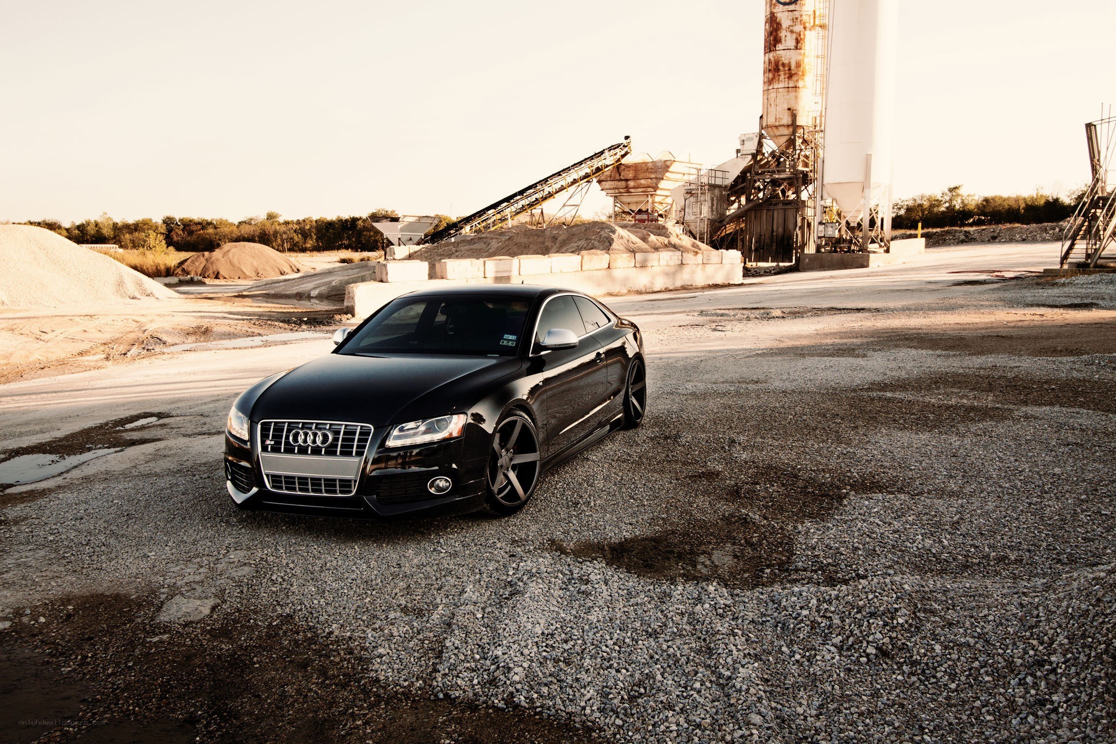 Black Audi in industrial setting