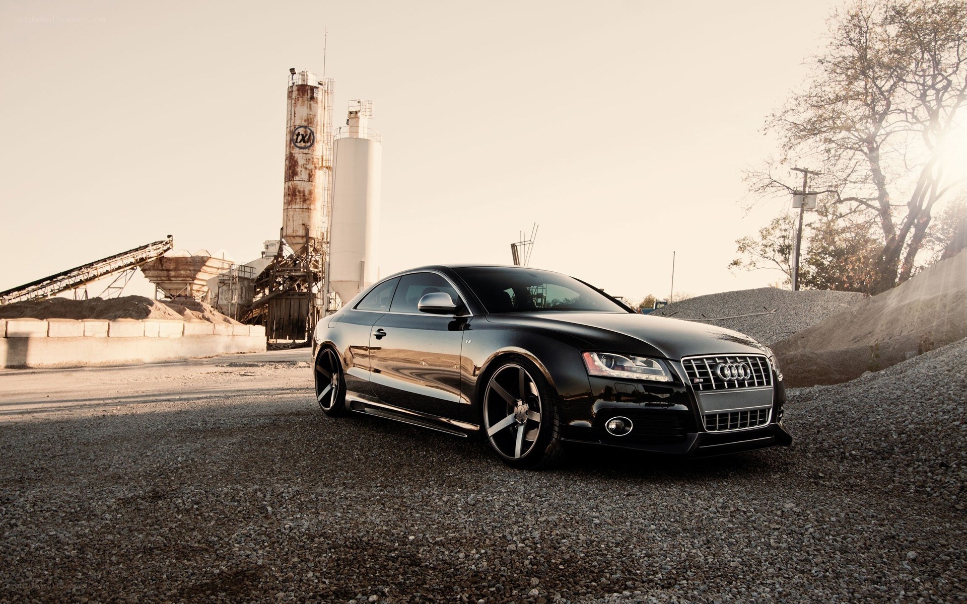 Black Audi in industrial setting