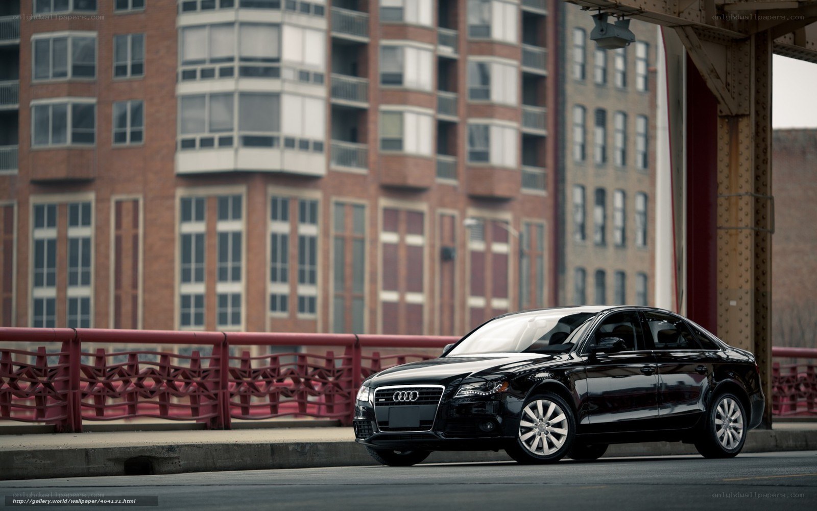 Black Audi on a city bridge