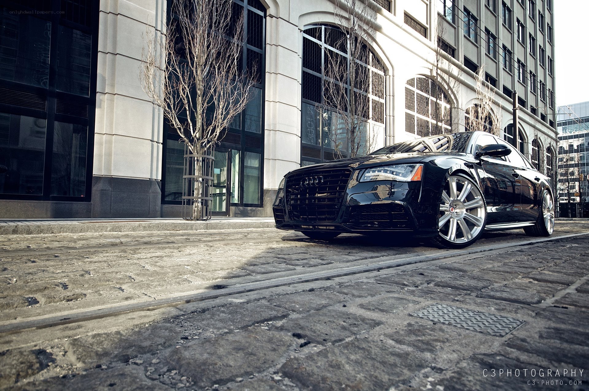 Black Audi on cobblestone street