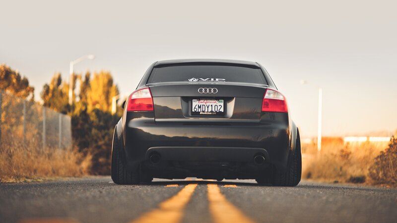 black audi on road at sunset