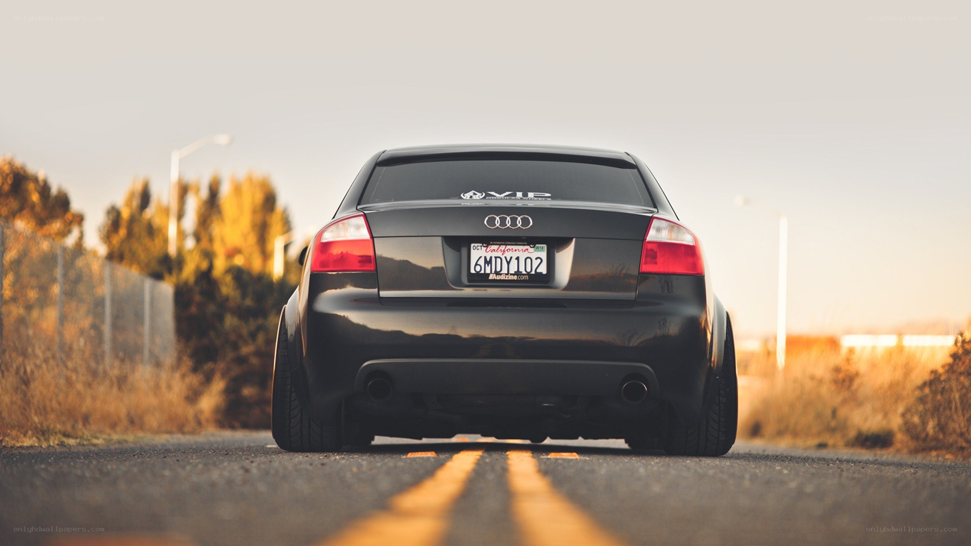 black audi on road at sunset