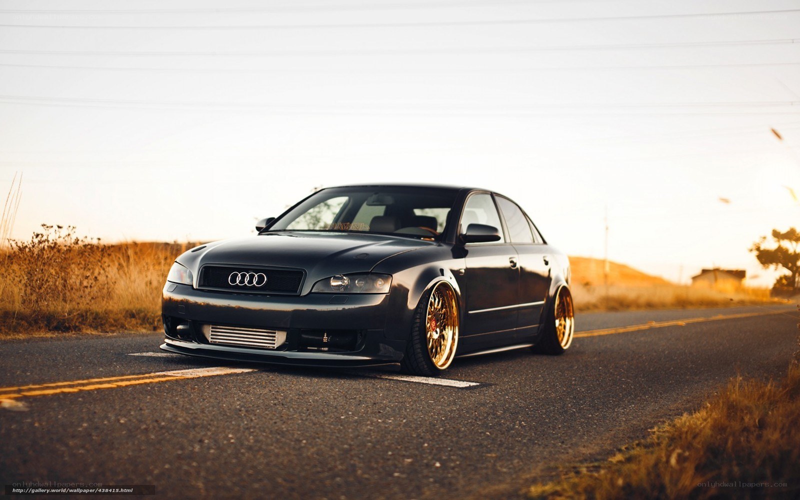 black audi on road at sunset